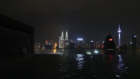 City-Skyscraper-Skyline-at-night-seen-from-rooftop-Infinity-Pool,-Kuala-Lumpur