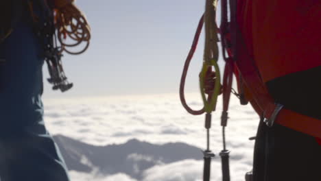 Trad-Climbers-With-Cams-On-High-Altitude-Overlooking-Sea-Of-Clouds