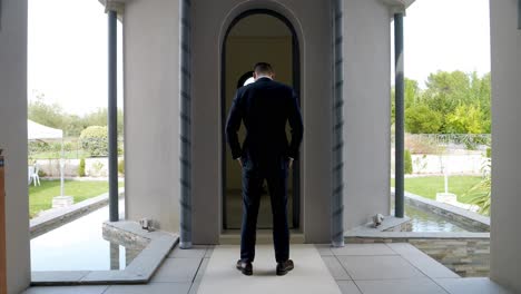 Slow-motion-shot-of-a-groom-taking-a-minute-before-the-wedding-ceremony-in-the-villa