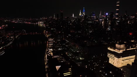 Aerial-view-of-the-illuminated-cityscape-of-Lenox-hill,-night-in-New-York,-USA