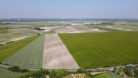 Green-Fields-With-Crops-Along-The-Road-With-Motor-Vehicles-In-Szalkszentmarton,-Hungary