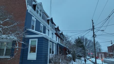 Aerial-low-shot-of-a-brick-house-with-blue-siding