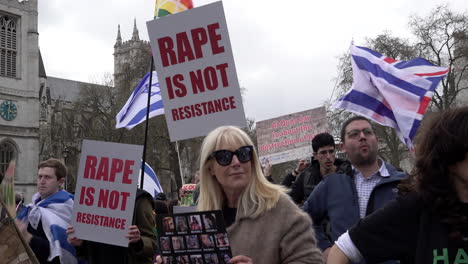 Pro-Israeli-people-hold-flags-and-various-placards,-some-that-read,-“Rape-is-not-resistance”,-on-a-counter-protest-to-the-annual-Al-Quds-day-demonstration