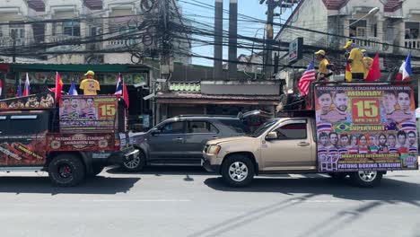 A-boxing-event-truck-with-posters-and-ads-on-both-sides-with-people,-announcing-the-upcoming-boxing-event-in-Phuket-Thailand