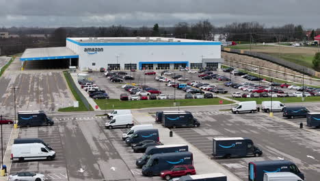 Aerial-drone-view-of-Amazon-Distribution-Center-exterior-and-parking-lot-on-a-cloudy-day