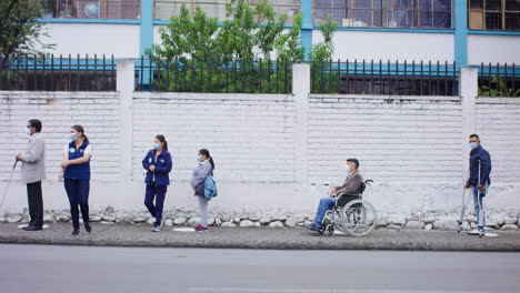 wide-shot-of-disabled-people-in-line-with-distance