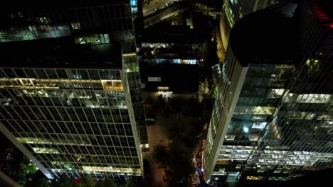 Nighttime-flyover-on-top-of-Modern-Office-buildings-of-Nueva-Las-Condes,-Business-district,-Santiago-de-Chile