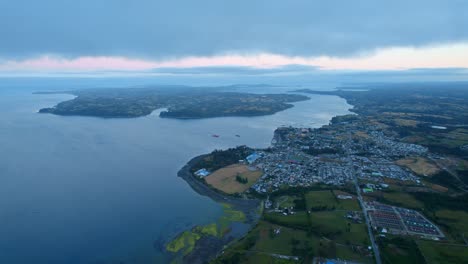 Aerial-view-of-the-Lemuy-island-with-Chonchi-in-the-background,-during-blue-hour