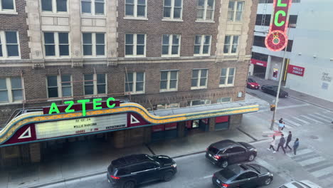 Downtown-traffic-in-San-Antonio,-Texas-at-the-Aztec-Theatre