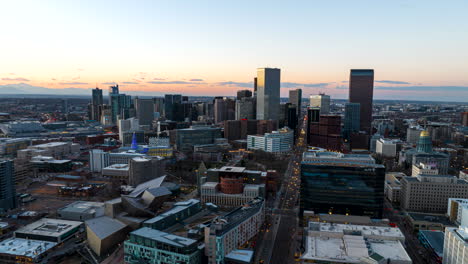 Twilight-aerial-hyperlapse-view-of-Denver-skyline,-traffic-flow-down-Broadway