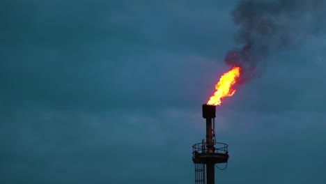 Flame-Torch-At-Oil-Field---Flames-From-Chimney-Pipe---Low-Angle-Shot