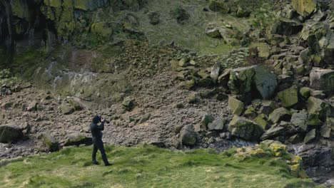 Slow-panning-shot-of-a-photographer-capturing-the-seabirds-breeding-on-Lunga