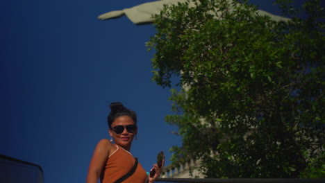 Una-Mujer-Sube-En-El-Ascensor-Y-Se-Deleita-Con-La-Vista-Trasera-Del-Cristo-Redentor-En-Río-De-Janeiro,-Brasil,-Mientras-Se-Acerca-Al-Emblemático-Monumento.