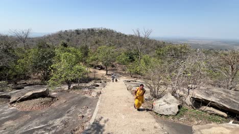 Woman-climbing-mountain-in-Maa-Kauleshwari-Temple,-Chatra-in-Jharkhand