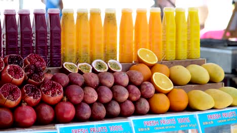 A-vibrant-display-showcases-fresh-fruits-and-juices,-arranged-artistically,-enticing-with-colors-and-flavors,-a-feast-for-the-senses