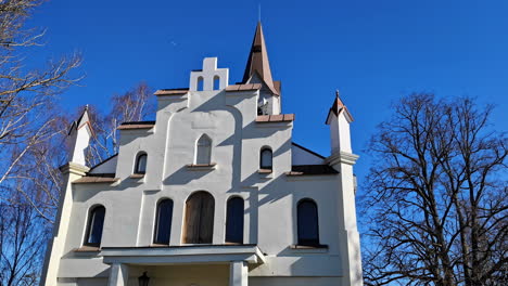 Church-white-plain-facade-tower-bell-religious-cult-worship-place