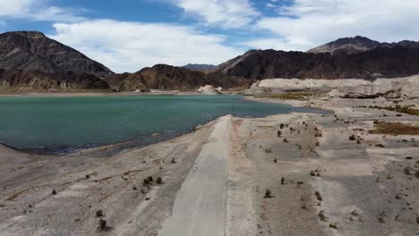 Aerial-descends-to-old-road-submerged-in-Argentina-hydro-dam-reservoir