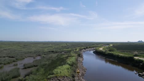 Serene-waterway-in-Veiros,-Estarreja,-under-a-clear-sky,-Portugal---aerial-fly-over