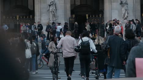 People-crossing-the-street-in-a-crowd-in-front-of-the-Opera-Garnier-in-slo-motion