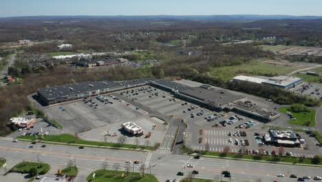 4K-Aerial-Drone-footage-of-industrial-shopping-centers-and-strip-malls-in-Middletown-New-York-and-traffics-can-be-seen-with-mountains-in-the-background