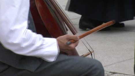 closeup-of-folklore-instrumentalist-playing-german-double-bass-with-bow