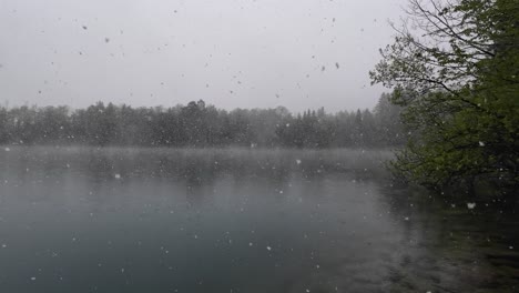 Snow-is-Falling-on-Lake-with-Fog-and-Mist-in-Austria,-Europe
