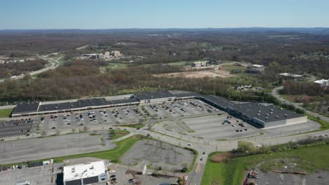 4K-Aerial-Drone-footage-of-industrial-shopping-centers-and-strip-malls-in-Middletown-New-York-and-traffics-can-be-seen-with-mountains-in-the-background