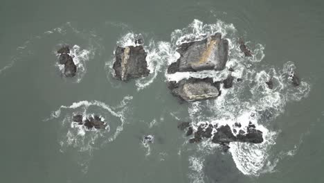 Top-down-aerial-view-of-the-rugged-and-rocky-coastline-of-the-Oregon-coast,-USA,-natural-allure-where-land-meets-sea