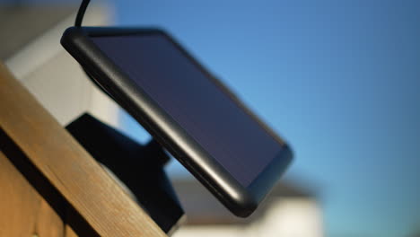 A-small-solar-panel-mounted-on-a-wooden-fence