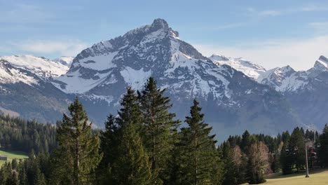 Alpine-majesty:-Amden-Arvenbüel-mountain-peak-in-spring,-Switzerland---aerial