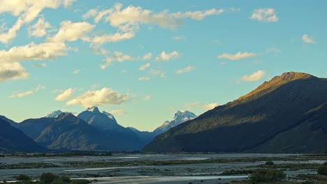 Golden-hour-glow-illuminates-sky-as-mountains-cast-shadow-across-lowlands-of-Glenorchy