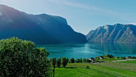 Aerial-View-of-Fairytale-Landscape-of-Norway,-Cruise-Ship-in-Fjord-and-Green-Coast-on-Sunny-Day