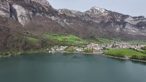 Verdant-shores-of-Walensee-beneath-the-Churfirsten,-Swiss-tranquility---aerial