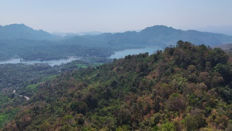 A-bird's-eye-view-of-mountains-and-jungle-in-Khao-Laem-National-Park,-Songklaburi,-Thailand,-showcasing-the-natural-beauty-of-the-region