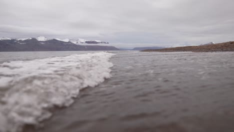 North-Sea-Waves-Breaking-on-Coast-Of-Greenland,-Coast-of-Fleming-Fjord-on-Cloudy-Summer-Day,-Slow-Motion