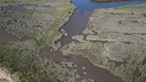 Abandoned-boat-in-marshy-Veiros,-Estarreja,-Portugal---aerial