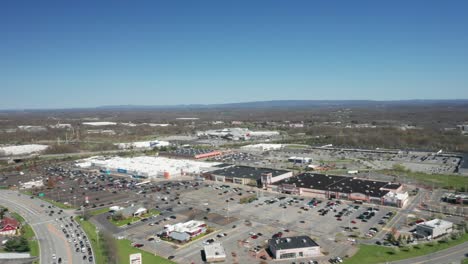 4K-Aerial-Drone-footage-of-industrial-shopping-centers-and-strip-malls-in-Middletown-New-York-and-traffics-can-be-seen-with-mountains-in-the-background