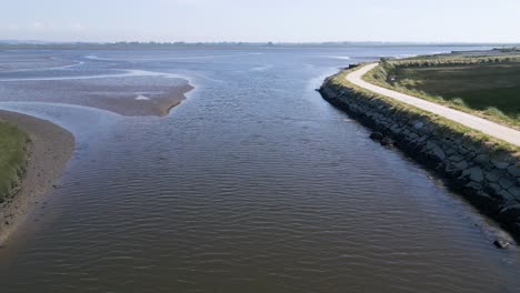 Serene-Ria-de-Aveiro-waterway-with-its-natural-bankside-pathways-in-Portugal---aerial