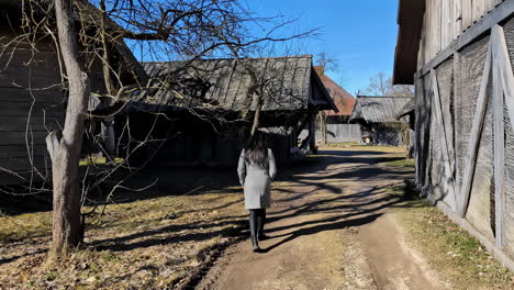 Young,-attractive-woman-walking-in-the-European-countryside-village-alone