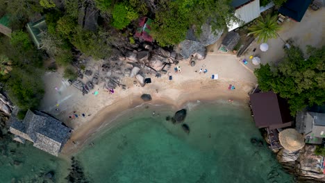 People-relaxing-on-stunning-tropical-beach---Aerial-overhead-drone-shot