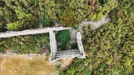 Aerial-View-of-the-Ruins-of-the-Ancient-Roman-Kadrema-Castle-Located-in-the-Gedelme-Village-and-Mountain-Ridge-on-Background