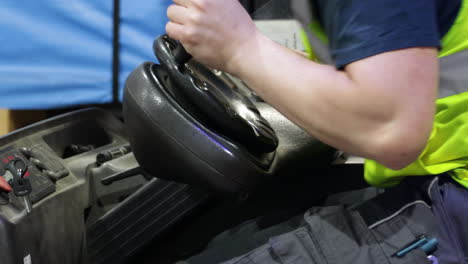 workers-driving-electric-forklift-inside-a-warehouse-close-up-on-skilled-hand-turn-the-steering-wheel