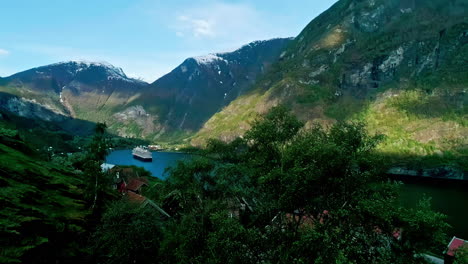 Aerial-Flam-village-Norway-fjord-shore-cruise-ship-mountains-valley-snow-peak