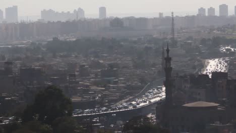 Cairo-traffic-in-one-of-the-streets,-a-video-from-the-highest-point-of-ancient-and-historical-Cairo-at-noon,-showing-traffic-flow