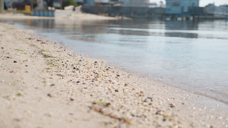 Close-Up-Delicate-Waves-on-Harbor-Sand