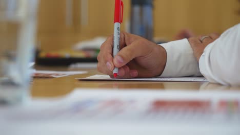 close-up-of-man-holding-pen