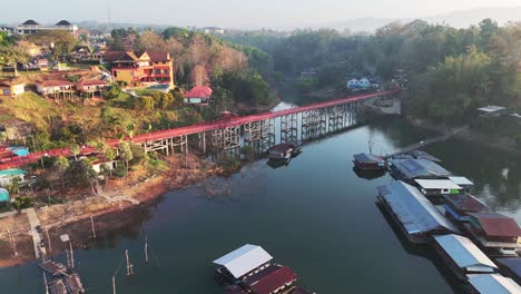 Aerial-close-up-of-the-iconic-Mon-Bridge,-a-landmark-in-Songklaburi,-Thailand