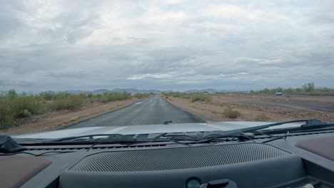 Rain-in-the-Desert---POV,-driving-on-paved-road-through-the-Sonoran-Desert-in-southeast-Arizona-on-a-rainy-day