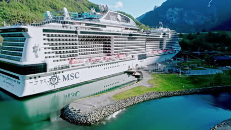 Aerial-View-of-MSC-Cruises-Ship-in-Port-of-Flam,-Norway-on-Sunny-Day,-Drone-Shot