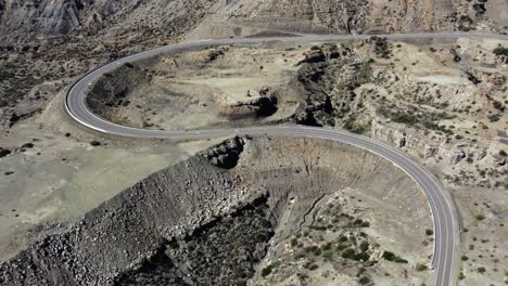 Aerial-rotates-over-highway-loop-overlooking-rugged-canyon-landscape